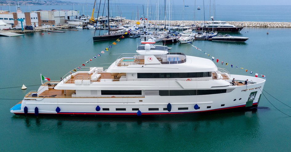 Crowbridge explorer yacht built by Cantiere delle Marche on calm waters with a number of other boats docked in the background