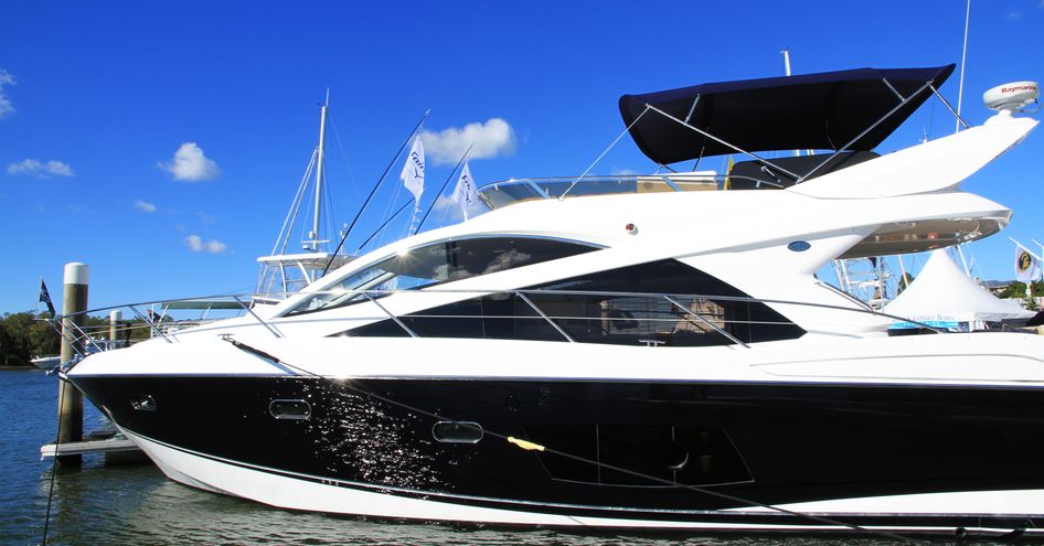 Side view of motor yacht berthed at Sanctuary Cove, Australia.