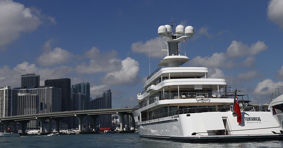 Yacht Haven Grande Miami during Superyacht Miami, superyacht berthed to starboard with Miami skyline visible on port side.