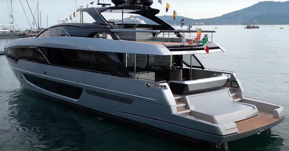 Aft view of Riva 102 Corsaro Super stern, yacht decorated with flags for launching ceremony. 