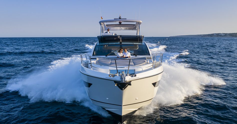 Onwards view of Pearl 62 flybridge yacht underway looking directly at the bow, surrounded by sea