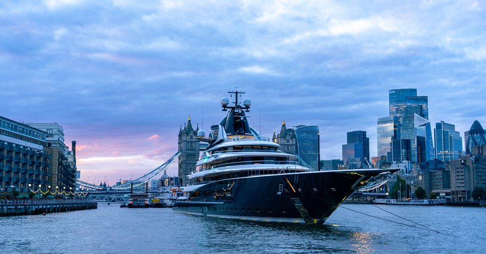 Kismet yacht at night  in front of Tower Bridge