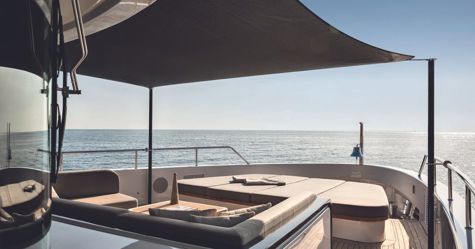 Overview of the Oasis 34M bow, with a bimini shading exterior lounge area