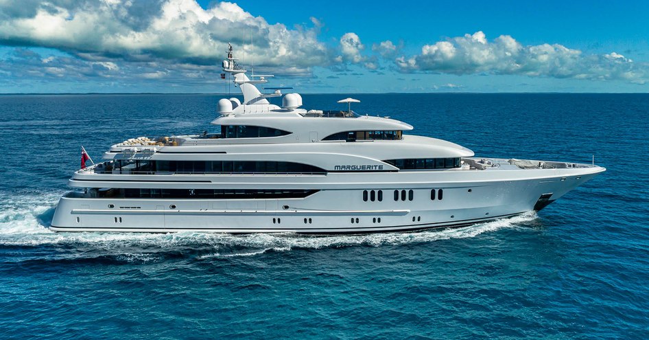 The superyacht MARGUERITE running through a calm blue sea, showing off her starboard side.