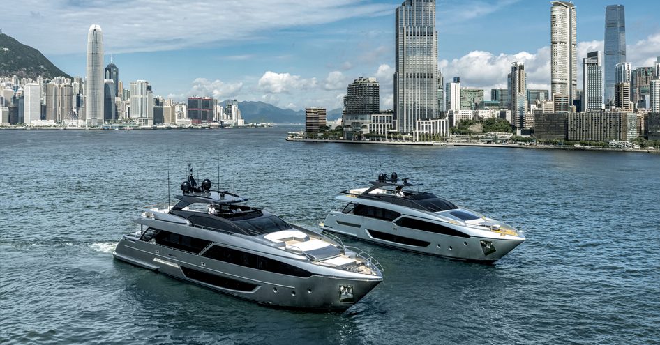 Riva yachts underway, surrounded by sea with cosmopolitan skyscrapers in background