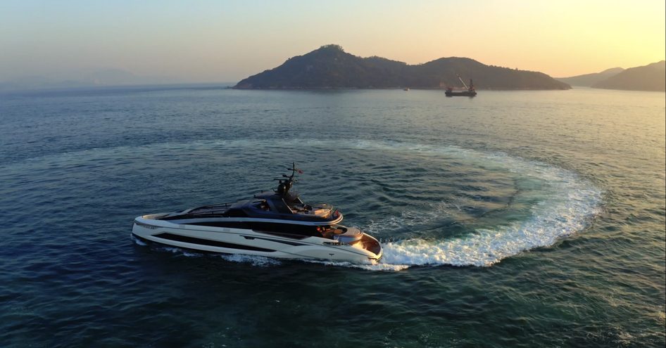 Superyacht Adamas 6 with rugged coast in background