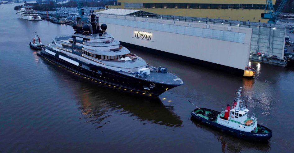 Superyacht LUMINANCE being towed from construction shed in Germany.