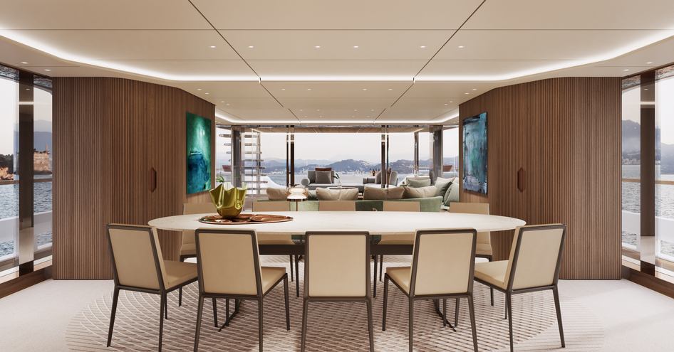 Main salon onboard Custom Line Navetta 50. Formal dining table in foreground with lounge area aft.