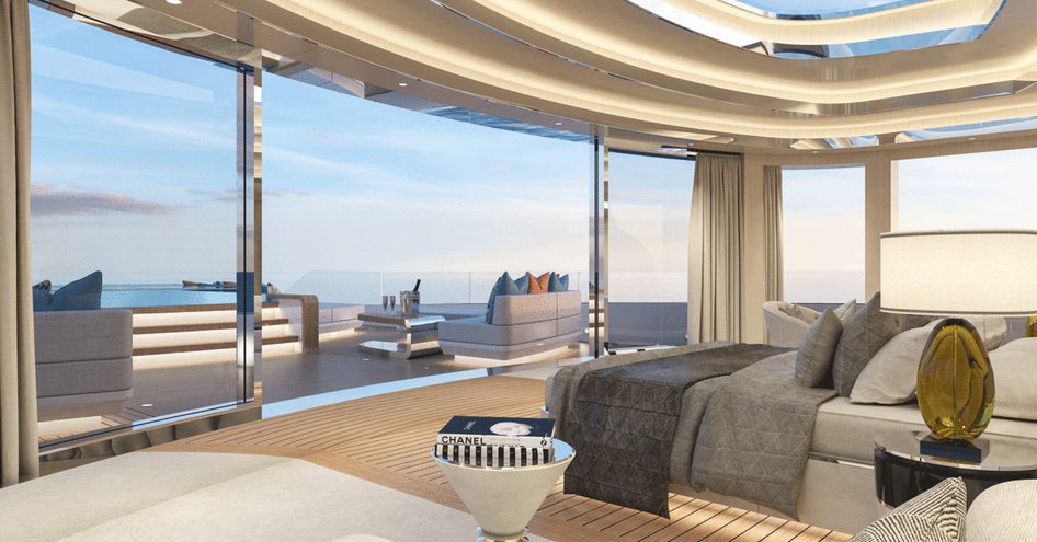 Inside Fincantieri Yachts BLANCHE owner's cabin, a central bed overlooks exterior seating and private Jacuzzi with panoramic windows