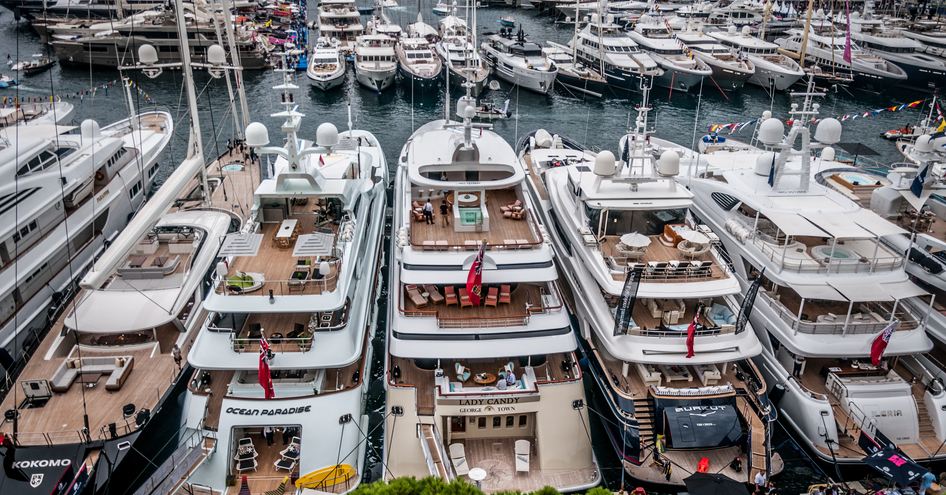 Aft view of superyachts moored at Monaco Yacht Show.