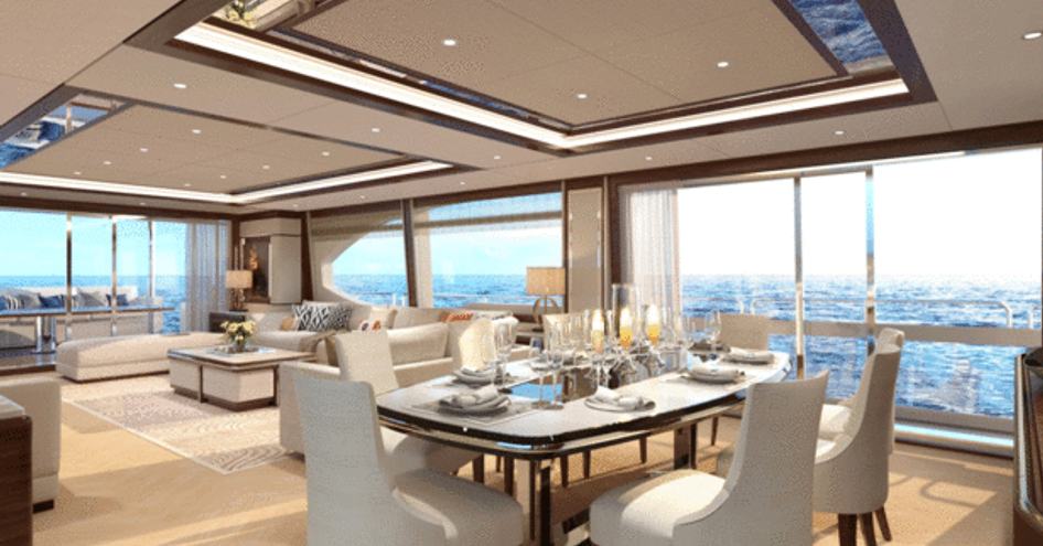 dining table surrounded by white chairs in the window-lined main salon of Asteria 108 from Heysea Yachts