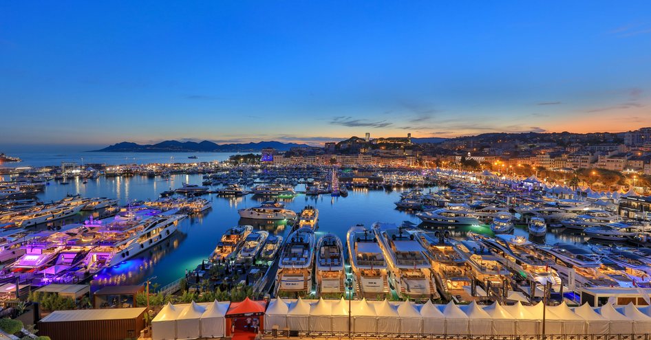 Evening panoramic view of the Vieux Port in Cannes, surrounded by sea