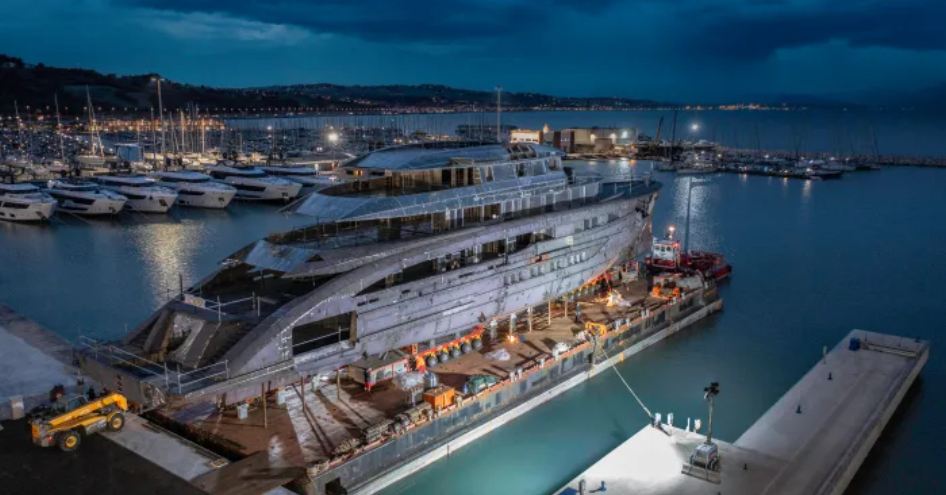 Aft view of CRN 143 Project Maranello docked at Ancona shipyard at dusk.