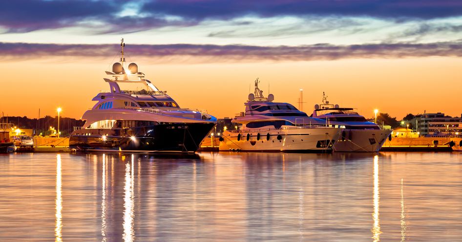 motor yachts in marina at sunset yacht charter