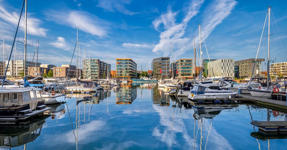 Overview of the harbour at Bremerhaven, Germany, with multiple sailing boats and motor yachts berthed at pontoons.