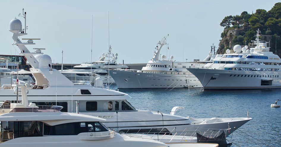 Superyachts moored at Port Hercule during Monaco Yacht Show.