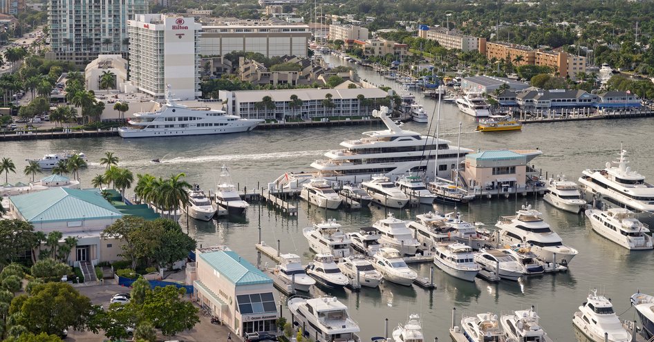 Pier 66 marina in Fort Lauderdale. Many motor yachts moored at berths, with hotels surrounding.