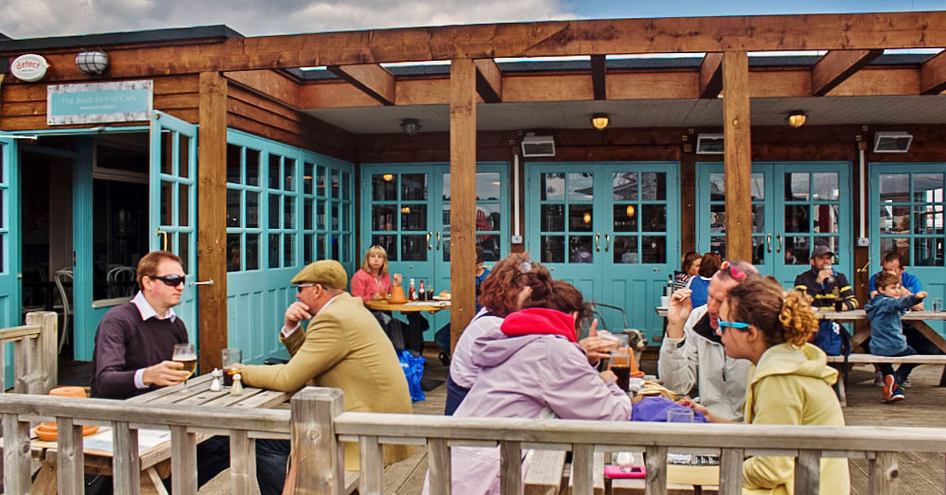 Visitors at the British Motor Yacht Show having drinks at one of the eateries around the marina.