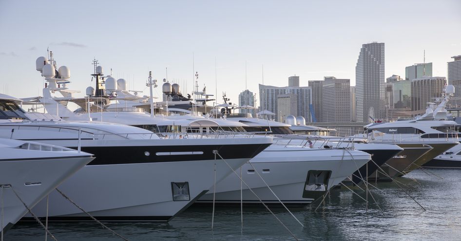 Boats lined up with large buildings in background