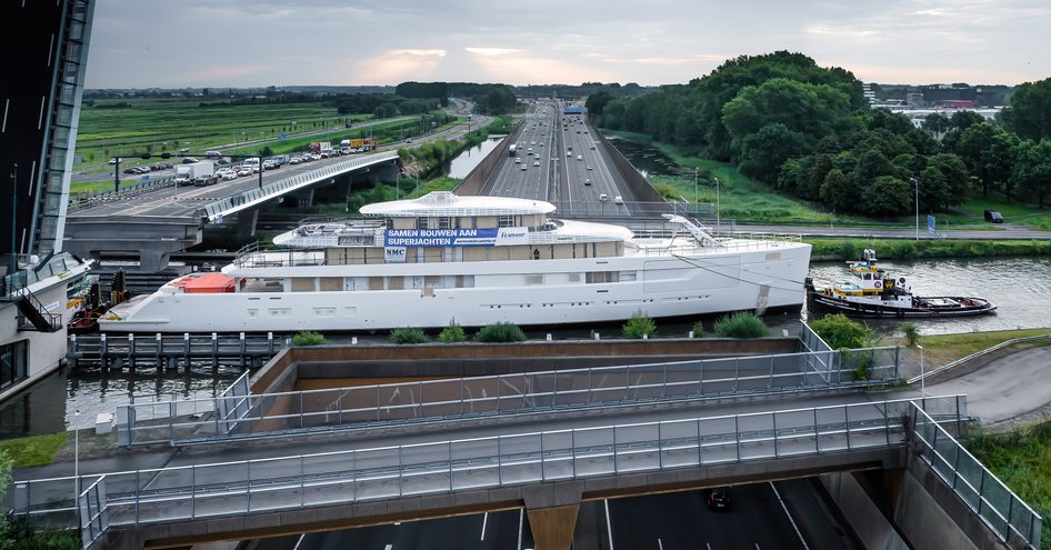 Feadship superyacht Project 825 being transported along Dutch waterway.