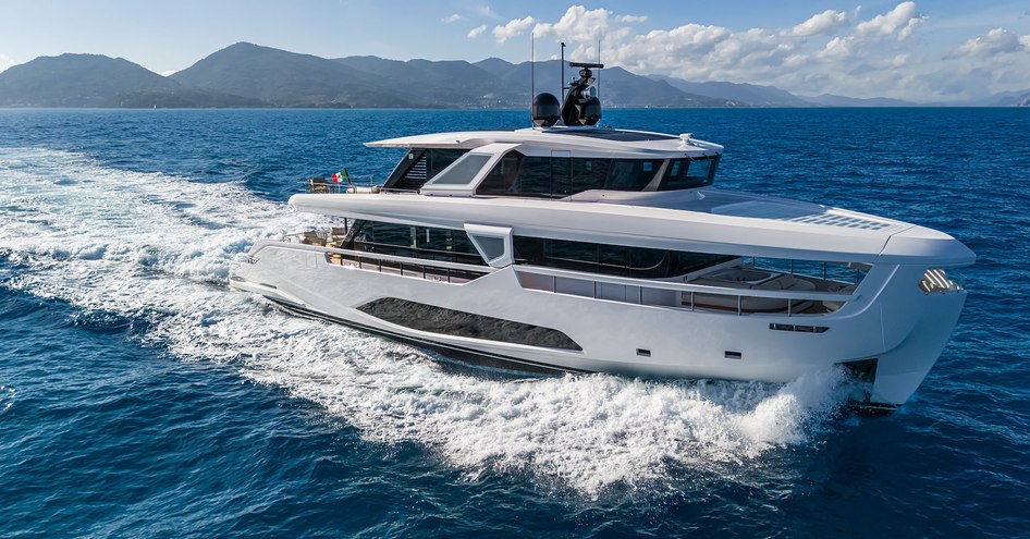 INFYNITO 90 running through choppy blue seas showing its extensive glazing on the starboard side