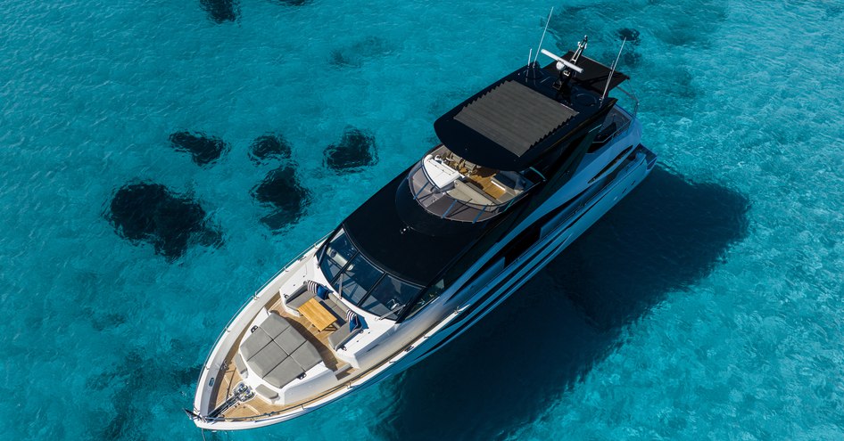 Bird's eye view looking down on Sunseeker 88 Yacht, surrounded by water.