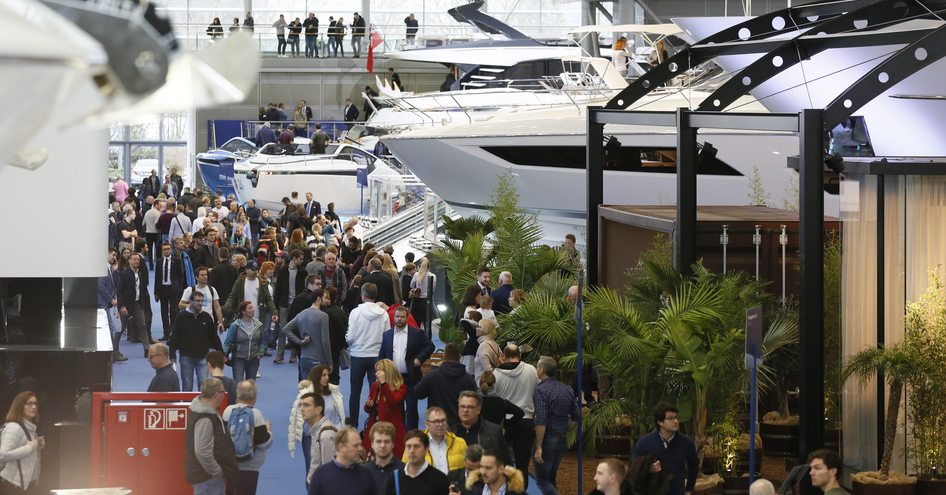 Crowd of people walking around large yachts at boot Dusseldorf