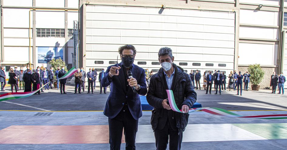 Two men cutting ribbon on opening of new shed