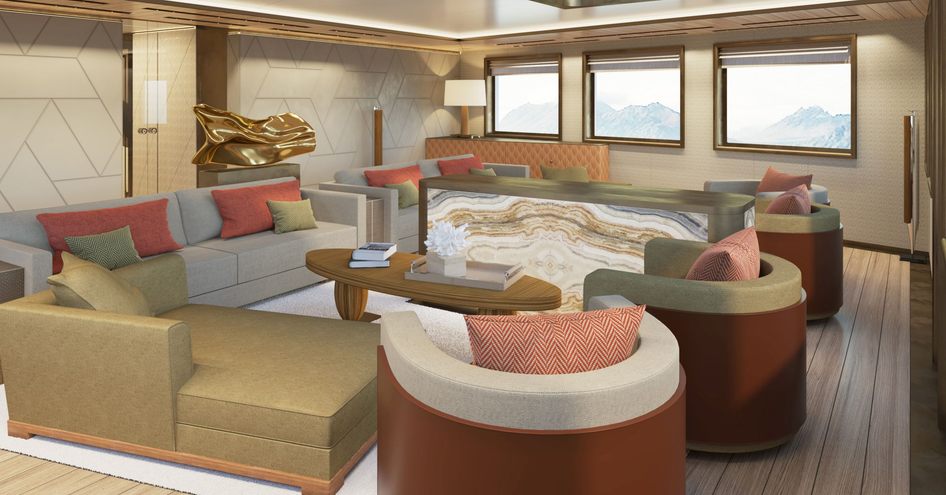 Lightly colored interior of Damen Yachting's 'La Datcha' Explorer Yacht, consisting of series of armchairs and sofas around a small wooden table with windows in the background