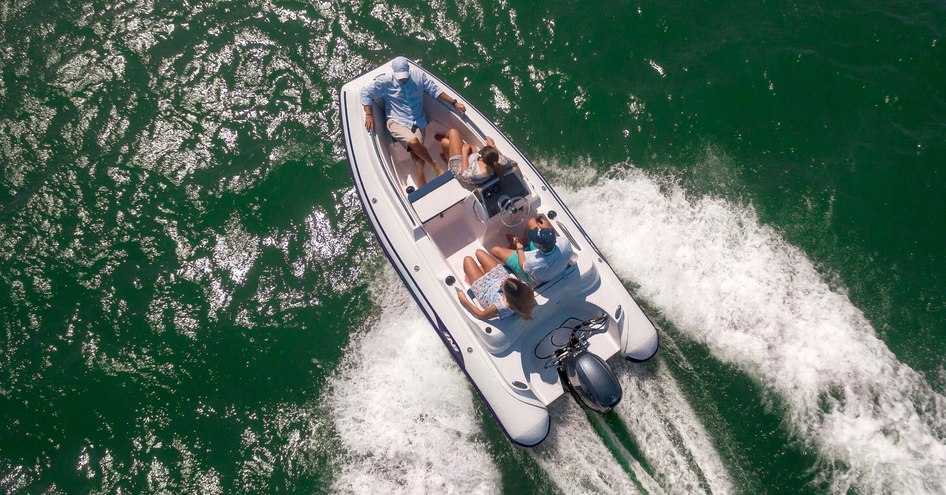 Four people on RIB tender viewed from above