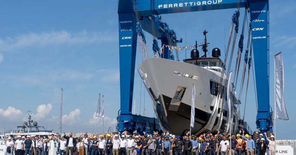 Custom Line 140 superyacht being lowered into the water at the Ferretti Group shipyard in Ancona.