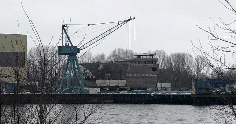 Bow of new Lurssen yacht being lifted by crane