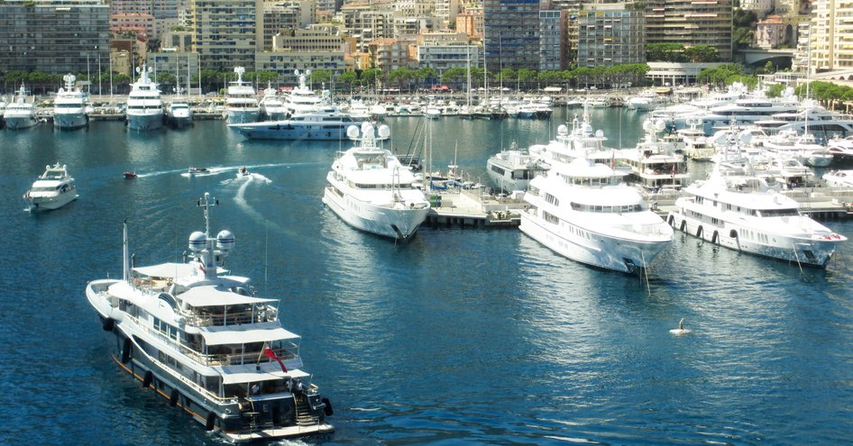 Aerial view of a luxury motor yacht arriving in the harbor in Monte Carlo