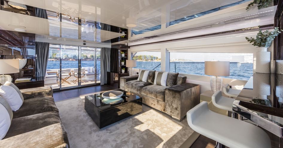 Interior of Pearl yacht with sofa, comfortable seats and expansive windows