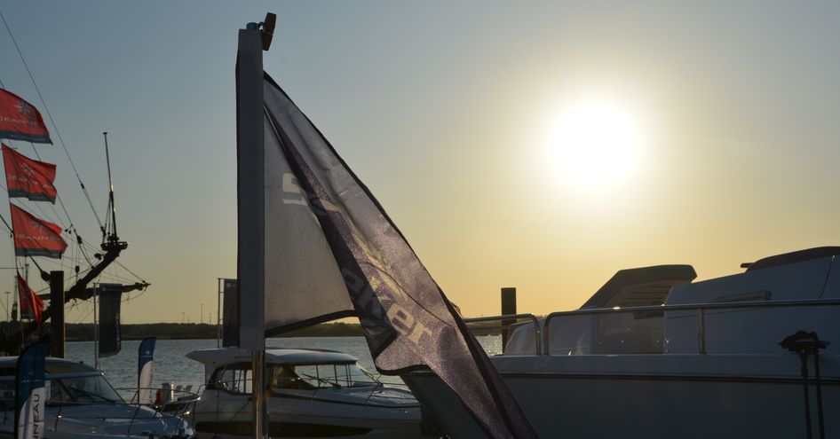 Sunseeker flag in foreground with yacht in background