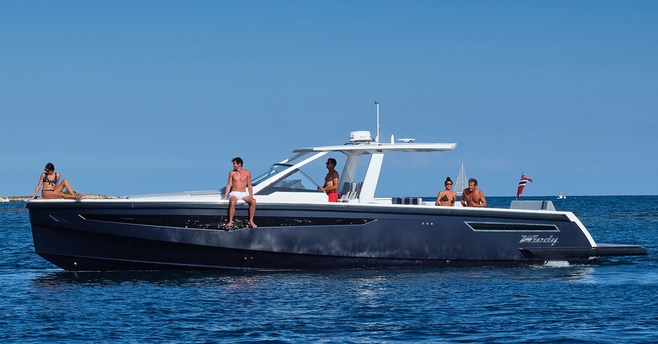 Chase boat anchored on sea with guests on board relaxing