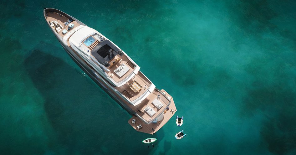 Estrade superyacht viewed from above, with three tenders at the rear and a wide expanse of water around it.