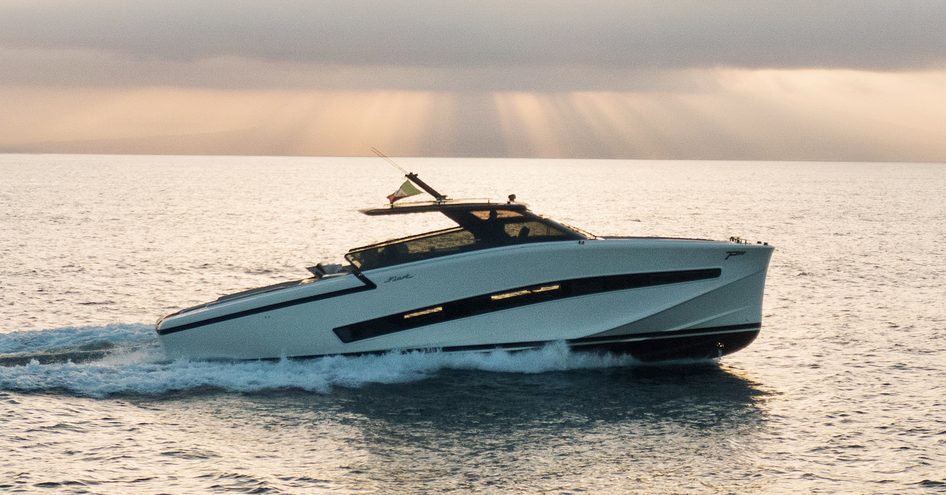 A starboard-side view of the Fiart Yachts P58 making way at dusk through a calm sea