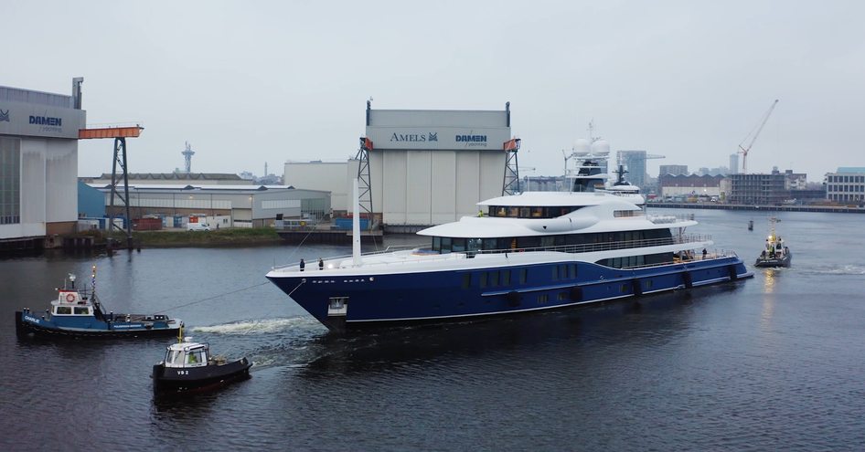 Amels 242 M&EM under escort on delivery day. Surrounded by Amels construction facility.