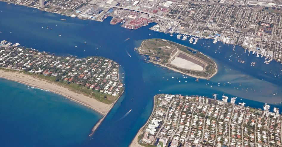 Aerial view of Port of Palm Beach with Peanut Island. Surrounded by sea and yachts at anchor.