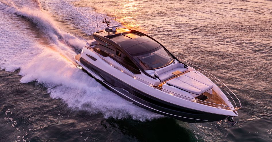 Sunseeker Predator 55 carving through a calm sea at dusk