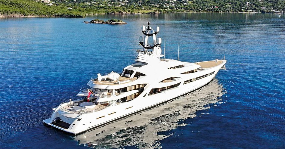 Superyacht ANNA on water with hills in background