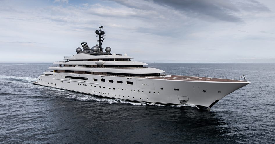 Lurssen superyacht BLUE underway, surrounded by sea on an overcast day.