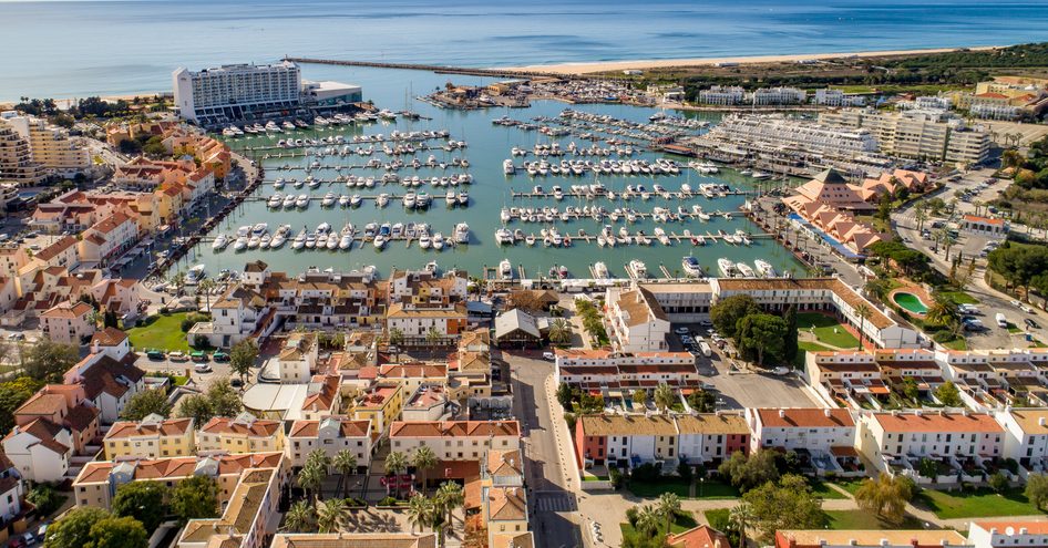 An aerial view of Vilamoura Marina in Portugal packed with yachts at berth along pontoons