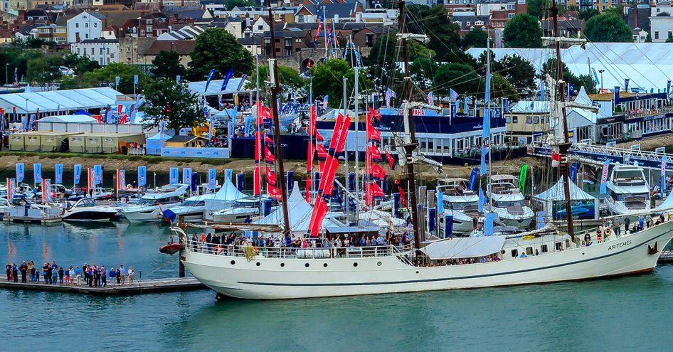 Sailing boat moored at Mayflower Park, Southampton. People queuing on dock waiting to embark.